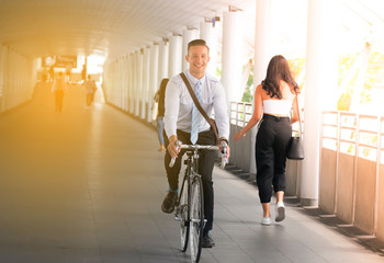 Businessman going to work by bicycle.Handsome man enjoying city ride by bicycle.