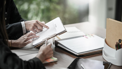 Business team consult and checklist on stock data with clipboard.