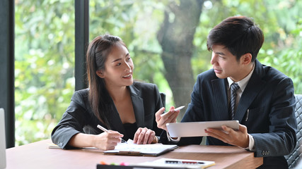 Young asian business people meeting with tablet on office table.