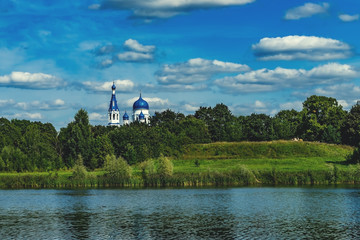 Magnificent summer landscape and Pokrovsky Cathedral in Gatchina, Russia. Beautiful sky with white clouds.