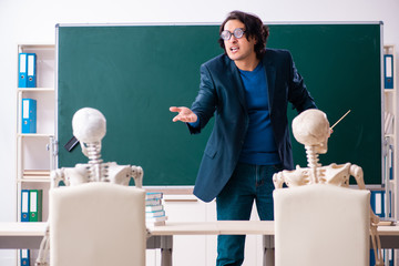 Male teacher and skeleton student in the classroom