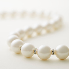 Pearl necklace on white background