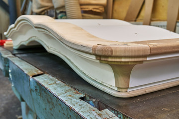 Fototapeta na wymiar Classic wardrobe crown molding. Production of wood furniture. Furniture manufacture. Close-up