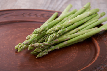 Seasonal product fresh green Asparagus on dark background