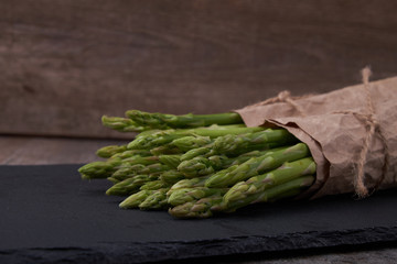 Seasonal product fresh green Asparagus on dark background