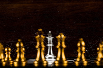 single silver king chess surrounded by a number of gold chess pieces and abstraction connection line network screen, business strategy concept