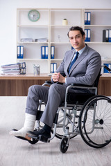 Male employee in wheel-chair in the office