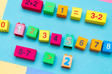 child kid colorful education toys cubes with numbers math pattern background on the bright background. Flat lay. Childhood infancy children babies concept.