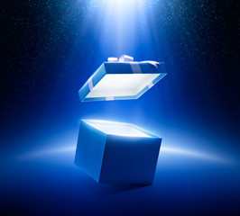 Blue open gift box on glittering background