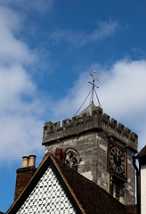 Stone built Norman tower circa 1220 AD with medieval rooftops in foreground