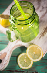 Fresh lemonade in a glass jar with slices of lemons