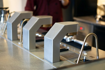 Under counter espresso system in the bar, Coffee machine pours espresso to glass shot then barista...
