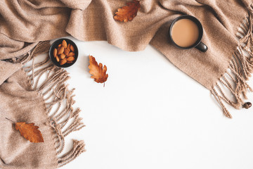 Autumn composition. Cup of coffee, plaid, autumn leaves on white background. Flat lay, top view,...