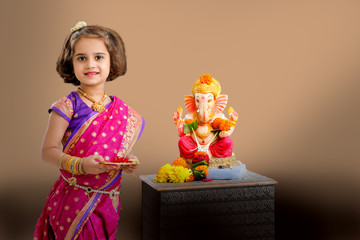 Little indian girl with lord ganesha, Indian ganesh festival