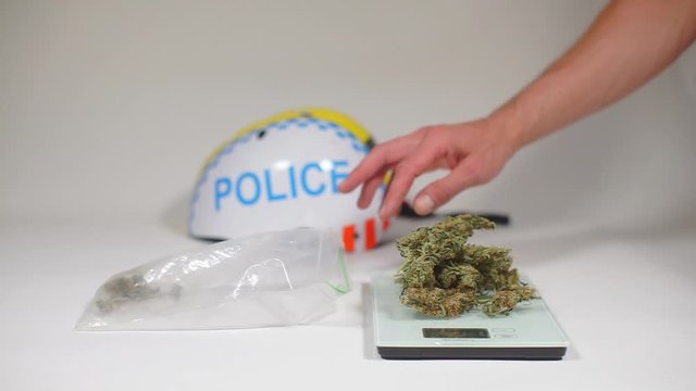 weed lies on the scales opposite the inscription police