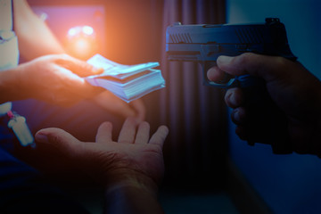 Armed robber using the gun to robbery the money with safe background. - obrazy, fototapety, plakaty