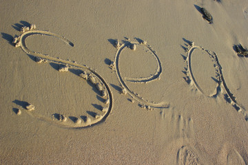 Lettering sea on sand sunrise background sea, beach dawn wave