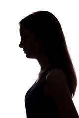 Young woman look down with flowing hair - vertical silhouette