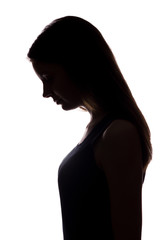 Young woman look down with flowing hair - vertical silhouette