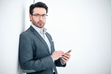 confident businessman typing SMS on your smartphone