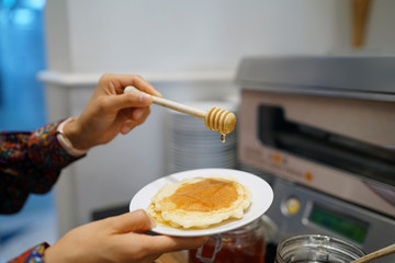 Homemade pancakes, topped with maple syrup.