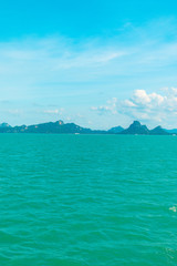 Fototapeta premium Looking at the Island, blue water and sky.