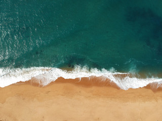 Aerial view of waves crashing onto the beach