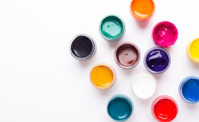 Multicolored gouache on a white background Isolated Paints in containers Top view Copy space