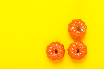 Decorative pumpkins on a yellow background. Halloween concept, harvest, autumn. Flat lay, top view