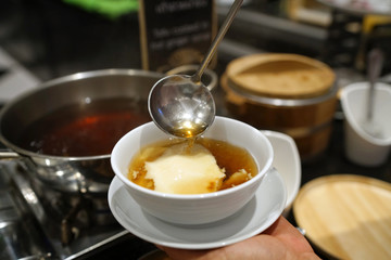 Homemade tofu pudding with ginger syrup, Chinese traditional dessert, Popular in Thailand.