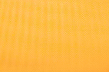 The texture of Karimat, an orange yoga mat. Can be used as wallpaper, background, texture.