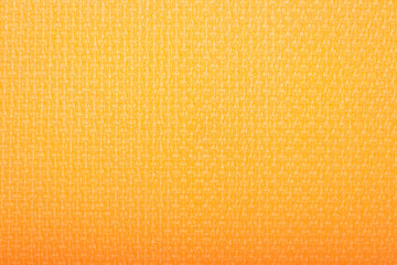 The texture of Karimat, an orange yoga mat. Can be used as wallpaper, background, texture.