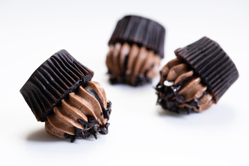 Chocolate cupcake fallen on white background