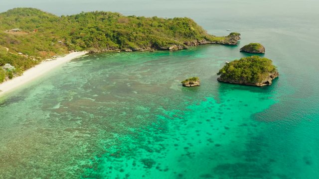 Tropical sandy beach near the blue lagoon and corall reef, aerial view Boracay, Philippines. Ilig Iligan Beach. Summer and travel vacation concept.