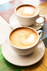 Cup of coffee with latte art on table