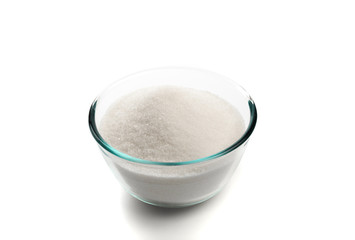 Sugar in glass bowl isolated on white background