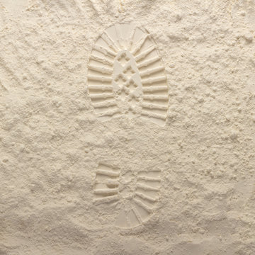 Footprint from a boot on a brown stone background. Moon surface texture. First step. Flat lay, top view