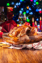 Baked or roasted whole chicken on Christmas table