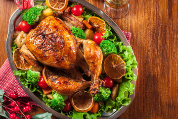 Baked or roasted whole chicken on Christmas table