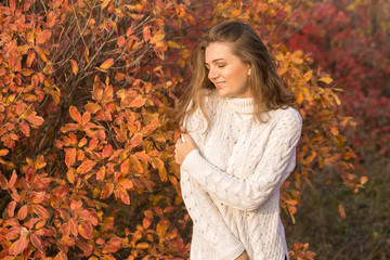 Autumn portrait of a girl in ethnic sweater