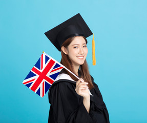 happy Young female graduation student showing the United Kingdom   flag