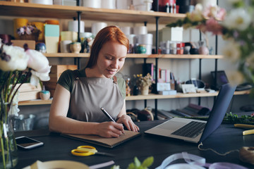 Florist making notes in sketchpad