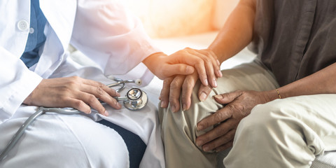 Parkinson's disease patient, Arthritis hand, gout knee pain, or mental health care with geriatric doctor consulting examining comforting elderly senior aged adult in medical exam clinic or hospital - obrazy, fototapety, plakaty