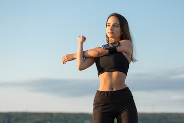 A young slim athletic girl in sportswear with snakeskin prints performs a set of exercises. Fitness...
