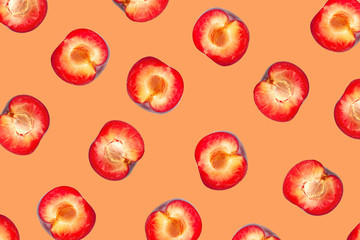 Great pattern with plum. Tropical abstract background. Plum slice on the orange background.