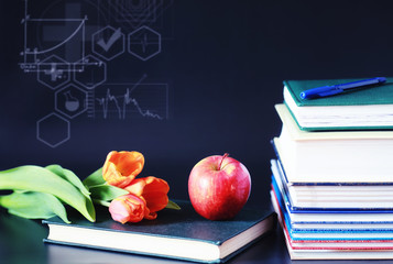 A stack of textbooks and books on the table. The concept of knowledge.
