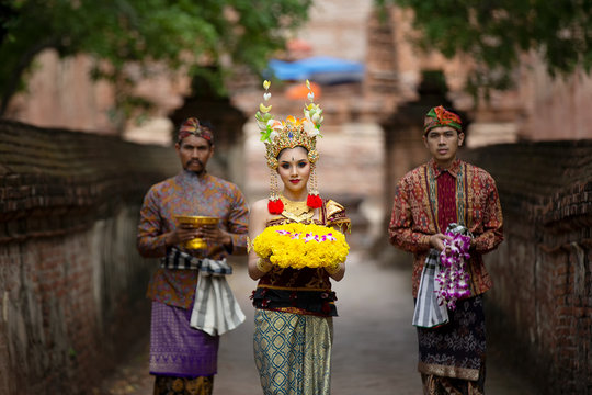 Portrait of an Balinese dancers is holding oblation after prayer in Traditional Attire at Bali Gate