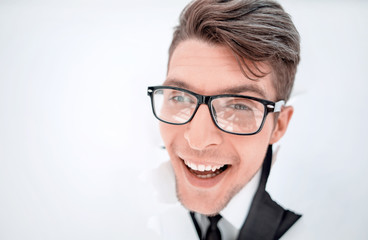 confident businessman breaking through a white paper wall