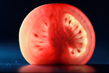 Red tomato cut in half with the texture of seeds