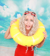 Impressed lifeguard works at beach, uses lifebuoy for saving people, wears pinup red spandex...